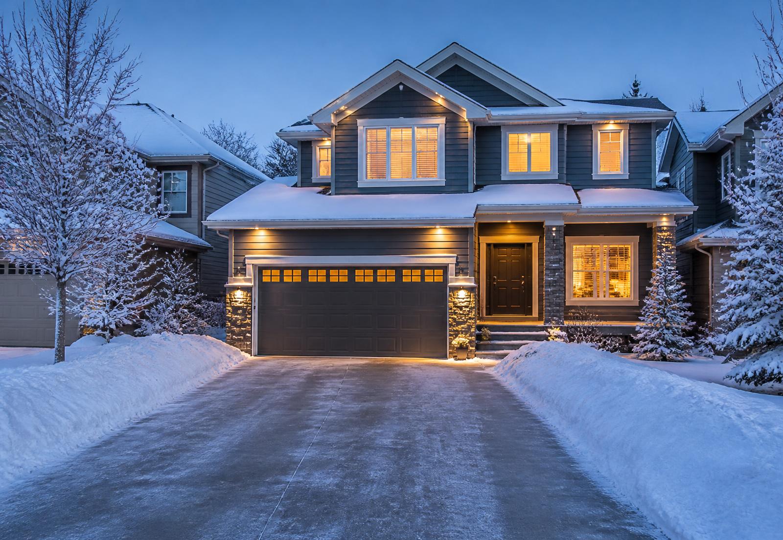 Freshly cleared driveway at dawn in a snowy Calgary neighbourhood
